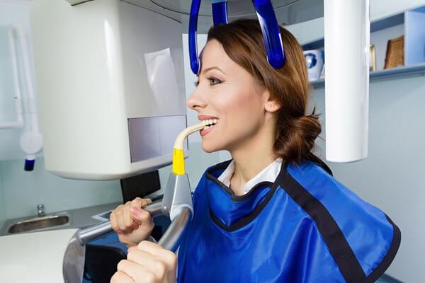 The Dental Studio Technology X-Ray Machine Being Used On A Patient